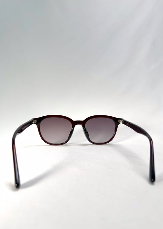 Back view of Elvor sunglasses in Mulberry Mist displaying the smooth temple curve and balanced round frame geometry. 