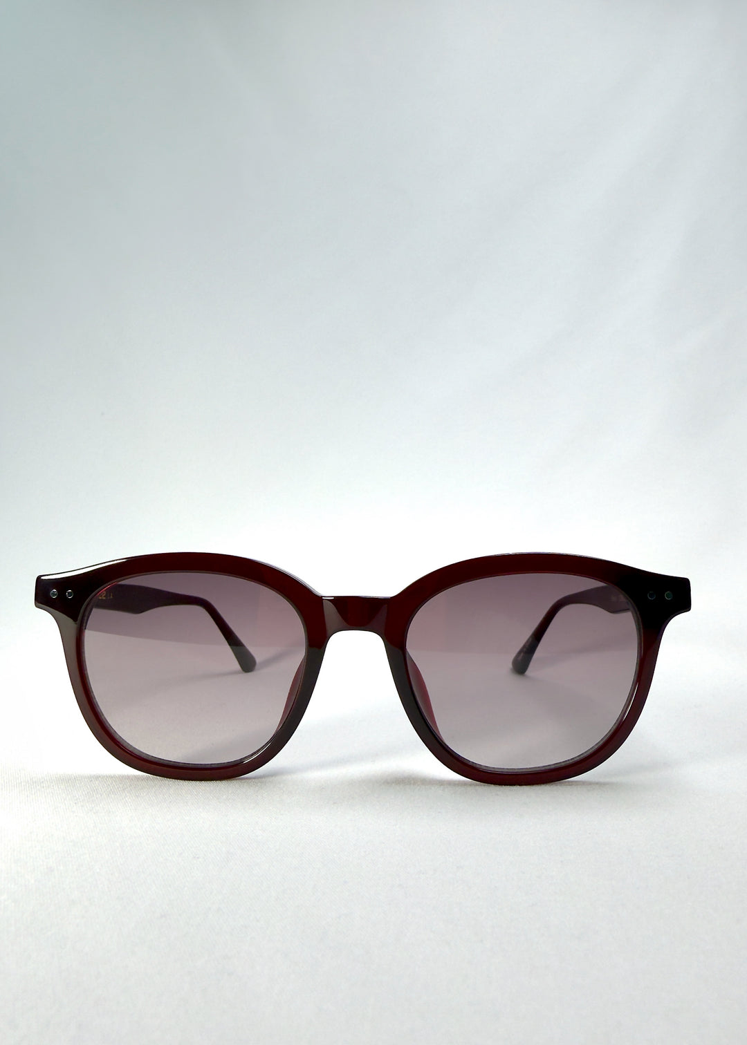 Front view of Elvor Softint sunglasses in Mulberry Mist featuring rounded frames and violet-to-grey gradient lenses for a vintage yet modern style.