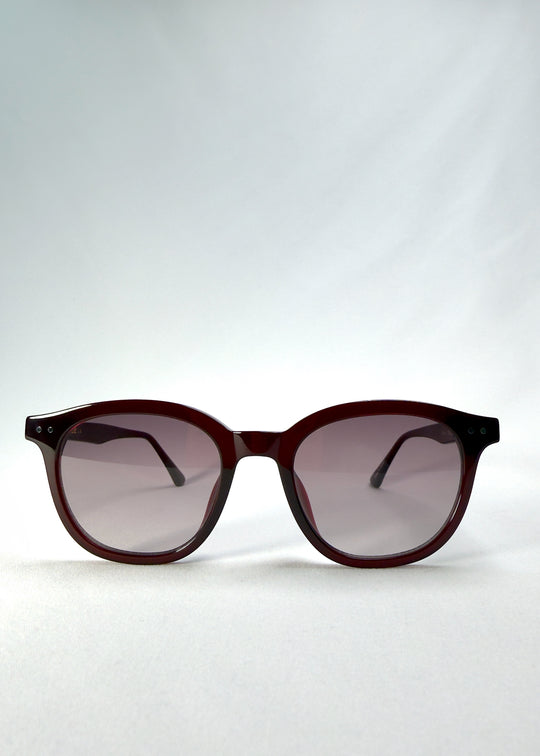 Front view of Elvor Softint sunglasses in Mulberry Mist featuring rounded frames and violet-to-grey gradient lenses for a vintage yet modern style.