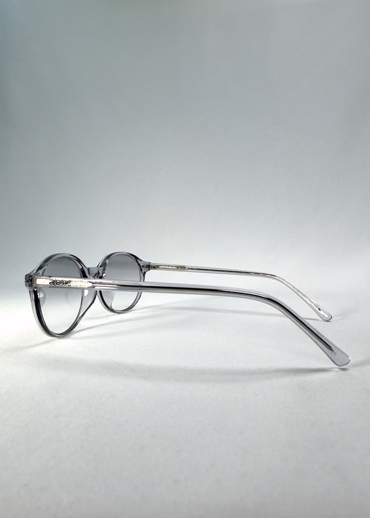 Back-angle view of Glint Softint sunglasses in Crystal Verge showing translucent grey acetate frame and gradient smoke lenses.