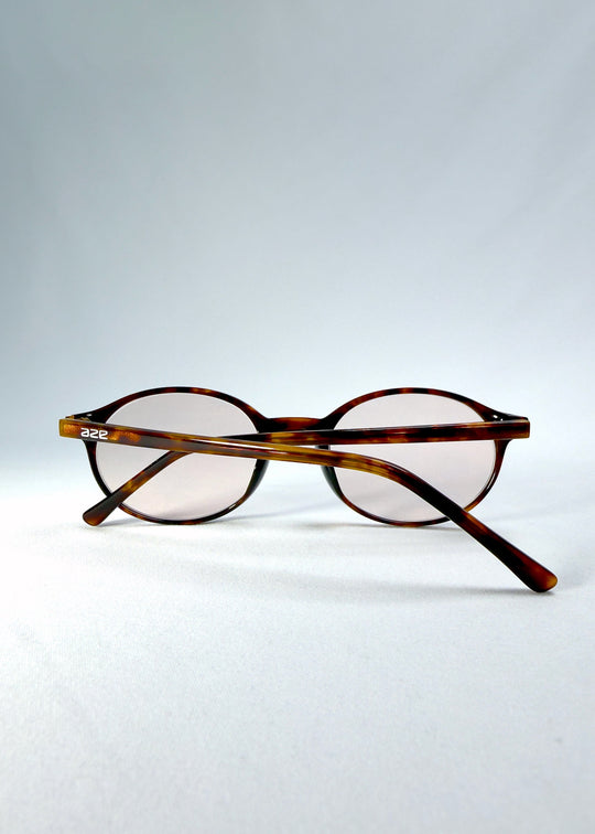 Side-temple view of Glint Softint sunglasses in Umber Ripple showing smooth acetate arms and hinge detail. 