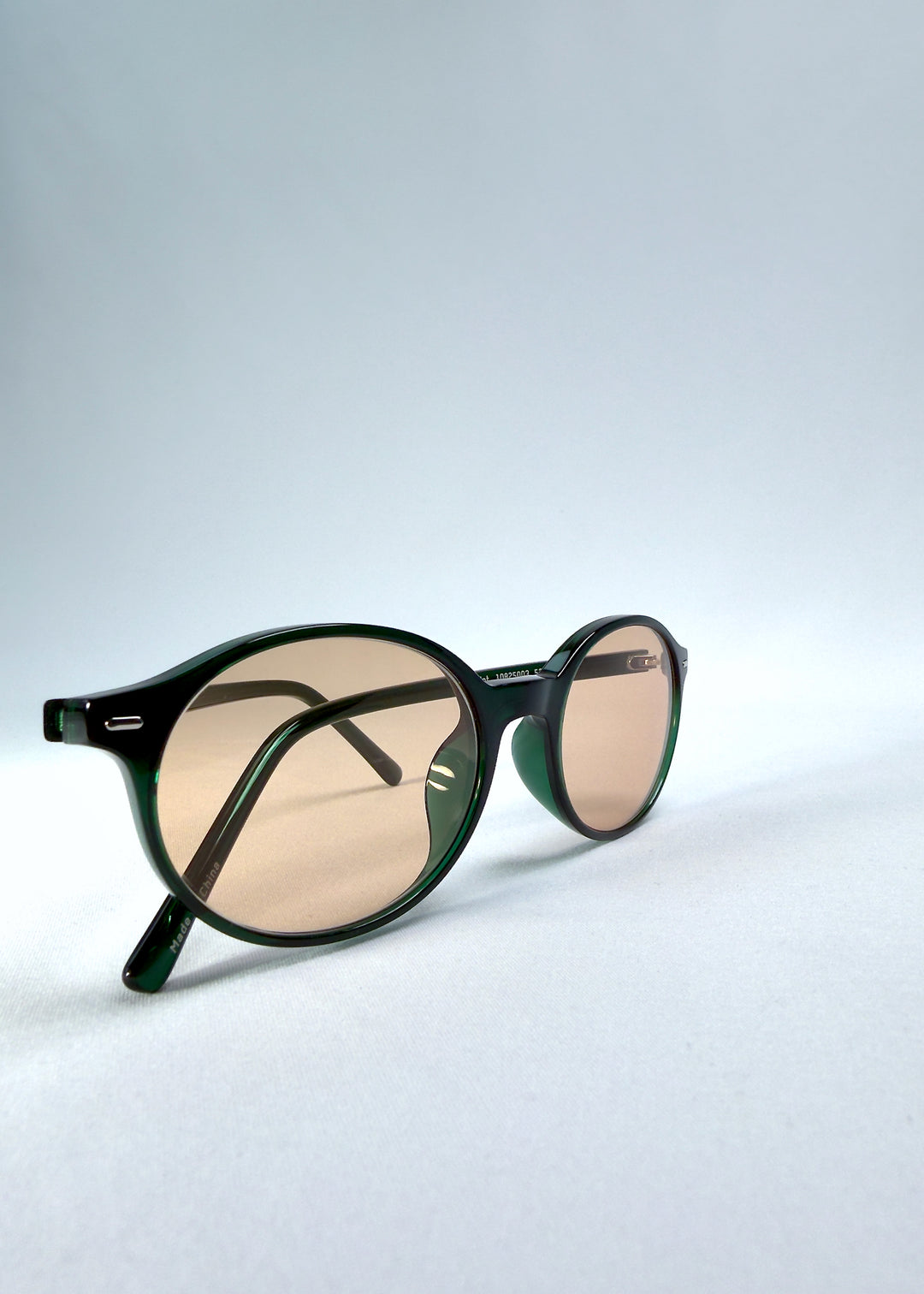 Close-up front-angle view of Glint Softint sunglasses in Verdant Halo emphasizing frame gloss and Softint lens hue.