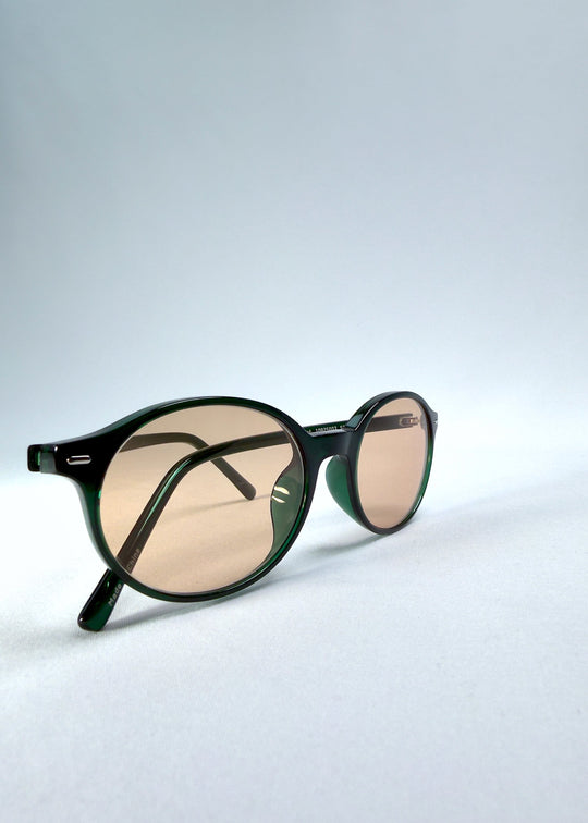Close-up front-angle view of Glint Softint sunglasses in Verdant Halo emphasizing frame gloss and Softint lens hue. 