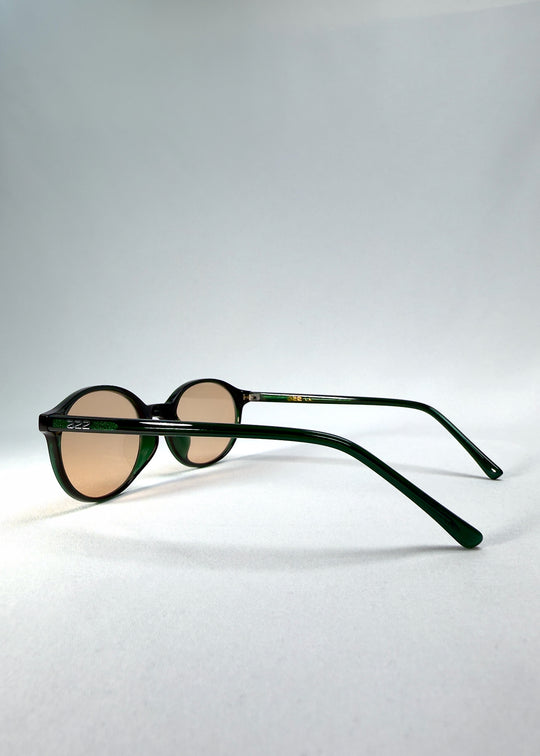 Side-temple view of Glint Softint sunglasses in Verdant Halo showing the smooth acetate arms and hinge detail.