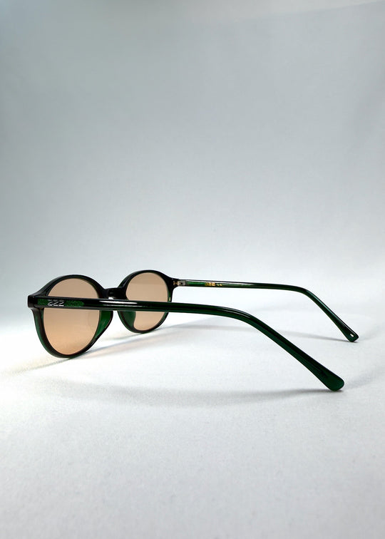 Side-temple view of Glint Softint sunglasses in Verdant Halo showing the smooth acetate arms and hinge detail. 