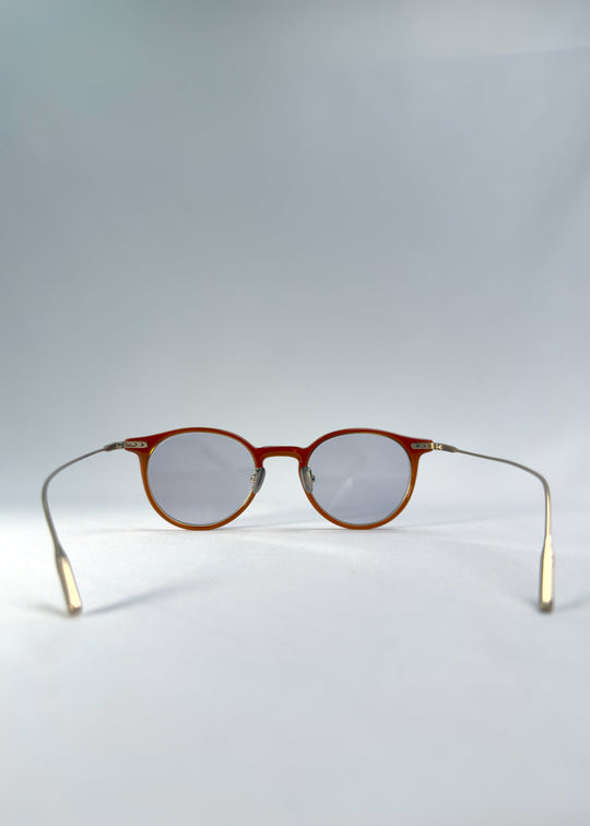 Back view of Lunor Drift Softint sunglasses in Amber Mist showing gold titanium arms and lightweight hybrid construction. 
