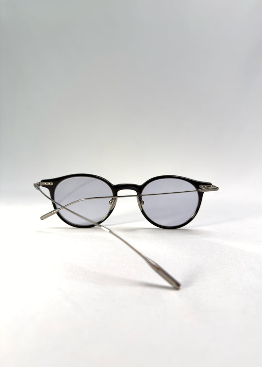 Back-angle view of Lunor Drift Softint sunglasses in Onyx Fade showing the black-to-silver acetate frame and titanium temples.