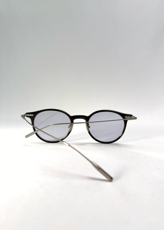 Back-angle view of Lunor Drift Softint sunglasses in Onyx Fade showing the black-to-silver acetate frame and titanium temples. 