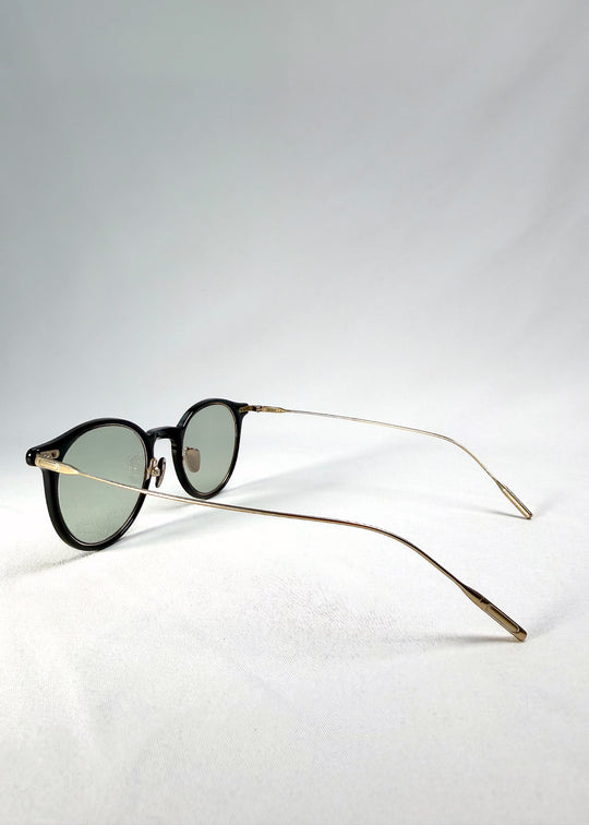 Back-angle view of Lunor Drift Softint sunglasses in Shadow Gleam showing translucent brown frame and gold titanium temples.