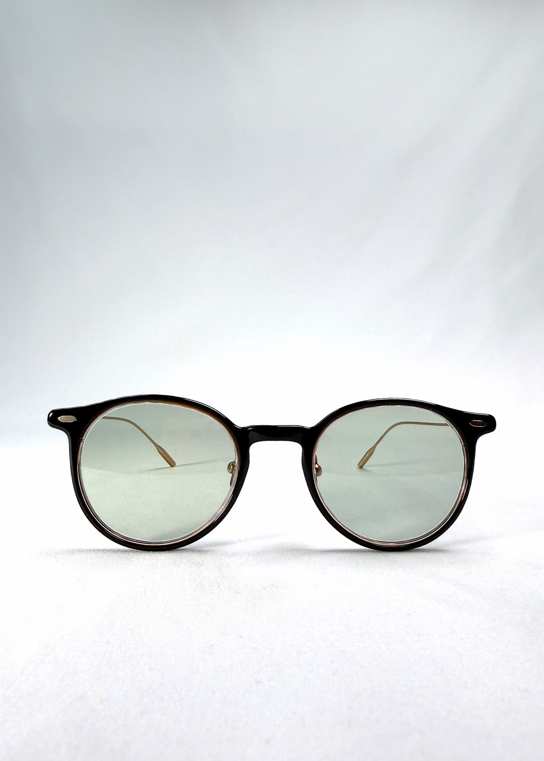 Front view of Lunor Drift Softint sunglasses in Shadow Gleam featuring round hybrid frame and softly tinted green-grey lenses.