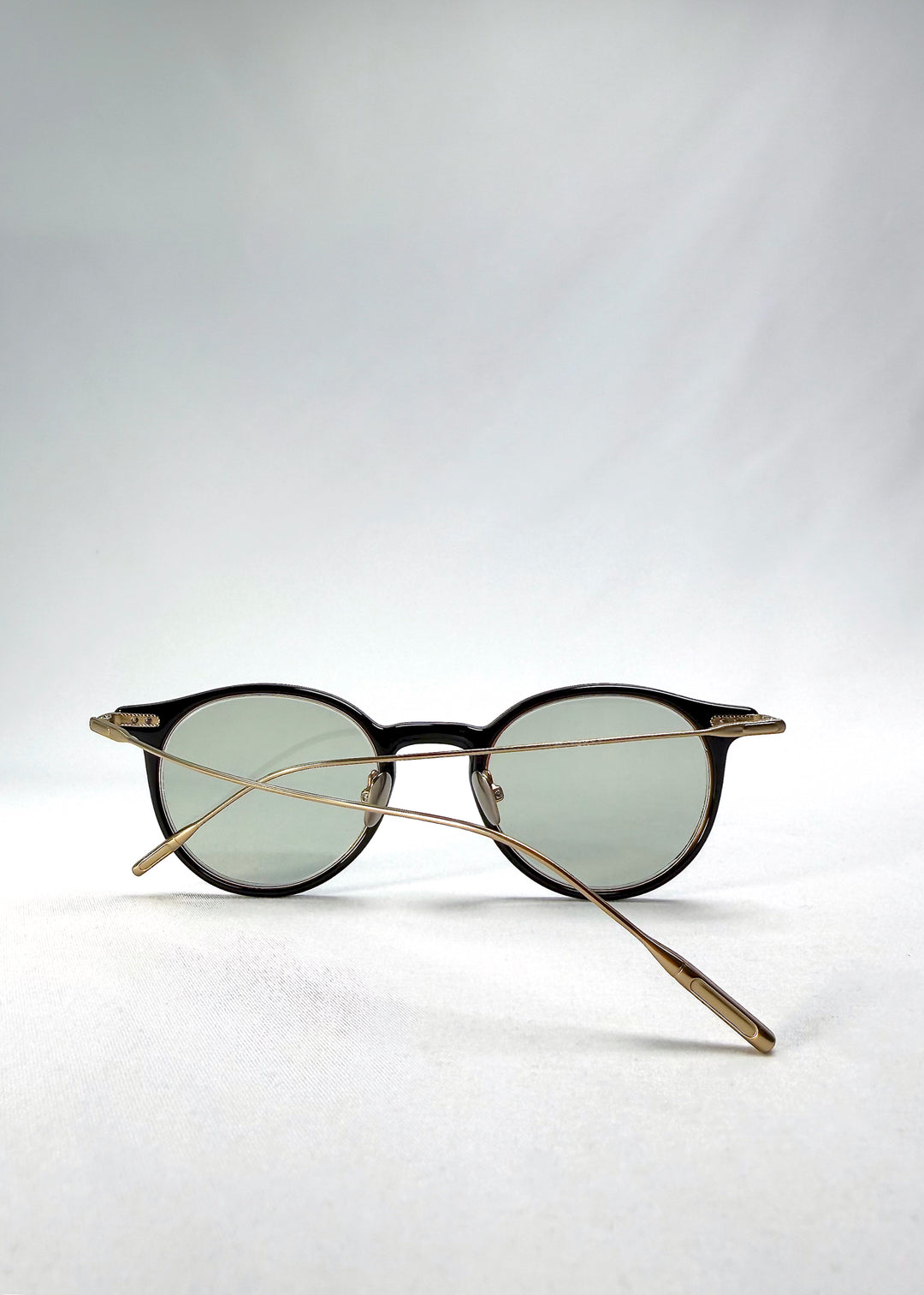 Side-temple view of Lunor Drift Softint sunglasses in Shadow Gleam showing curved titanium arms and hinge detail.
