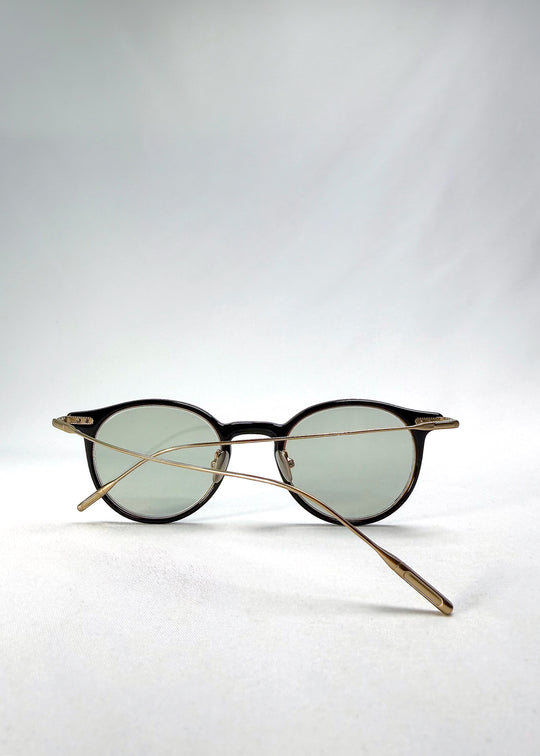Side-temple view of Lunor Drift Softint sunglasses in Shadow Gleam showing curved titanium arms and hinge detail.