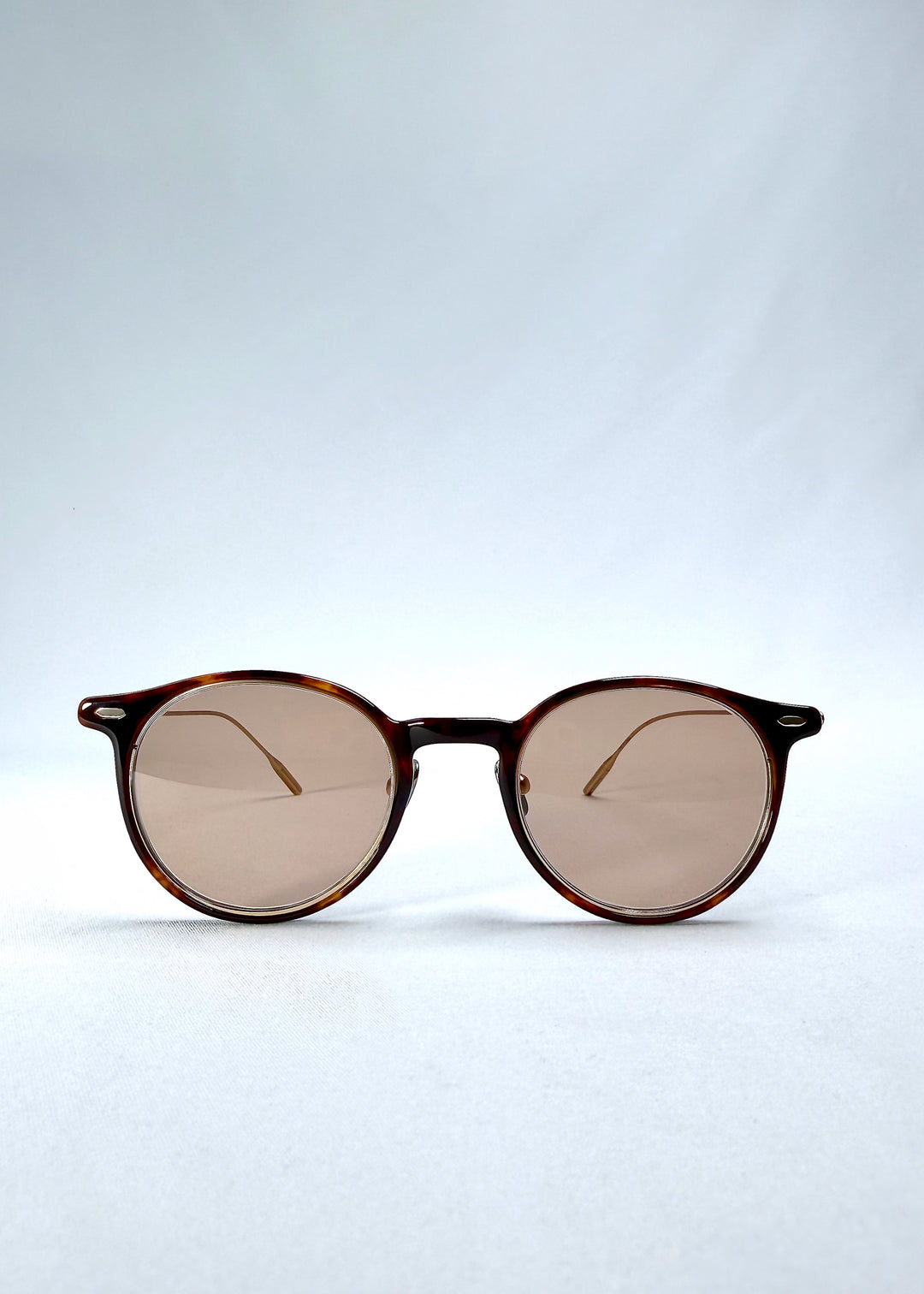 Front view of Lunor Drift Softint sunglasses in Umber Fade featuring round amber frame and rose-brown tinted Softint lenses.