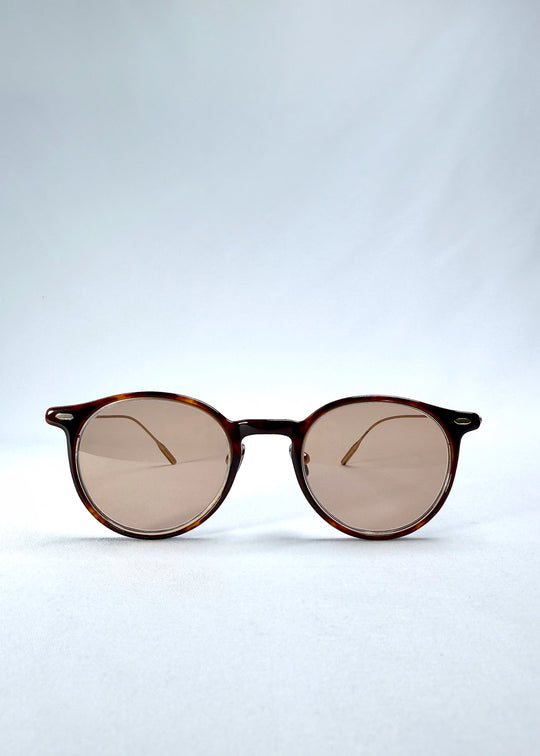 Front view of Lunor Drift Softint sunglasses in Umber Fade featuring round amber frame and rose-brown tinted Softint lenses.