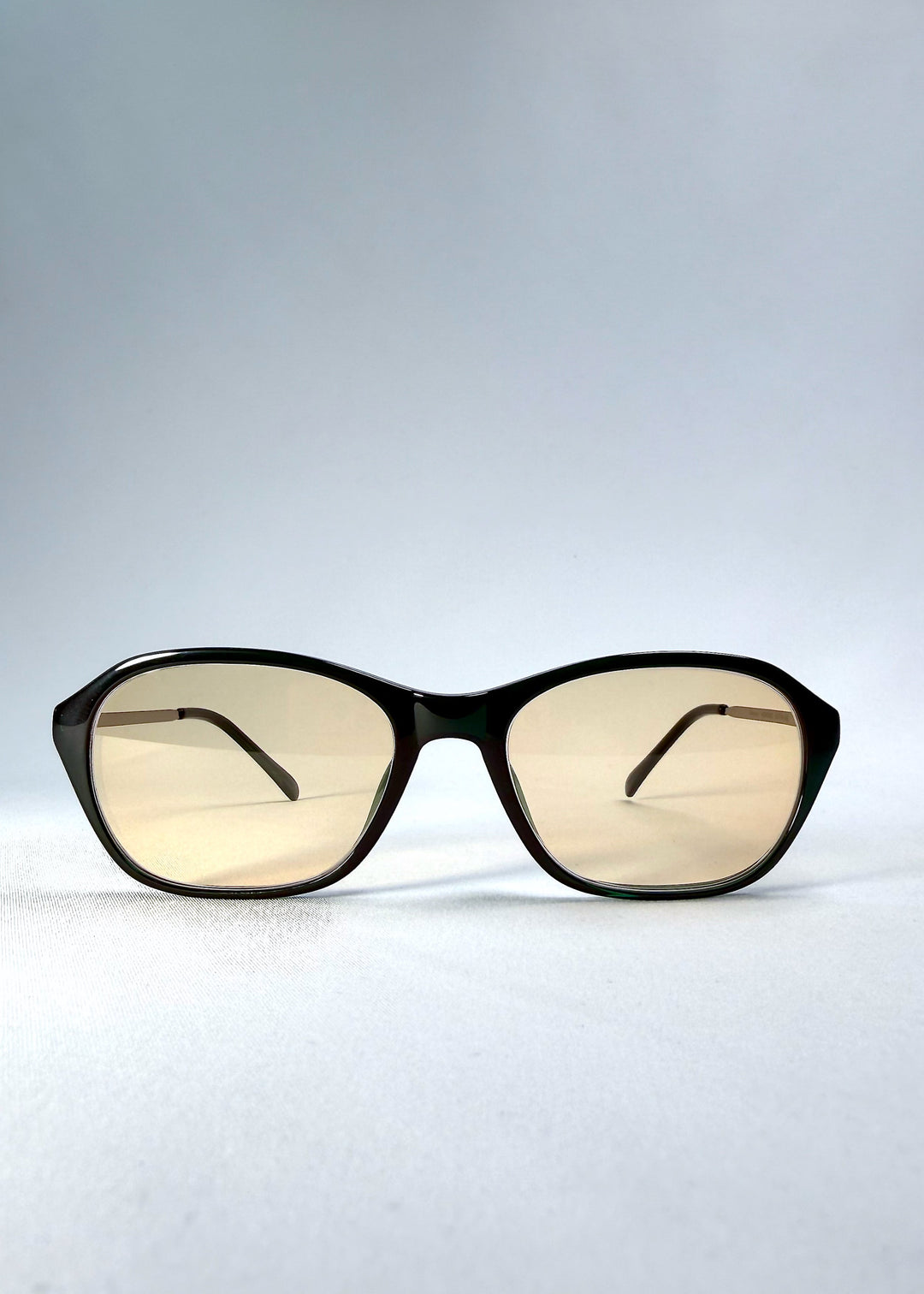 Front view of Ravynor Softint sunglasses in Jade Shadow featuring a deep green rectangular frame and light champagne Softint lenses. 