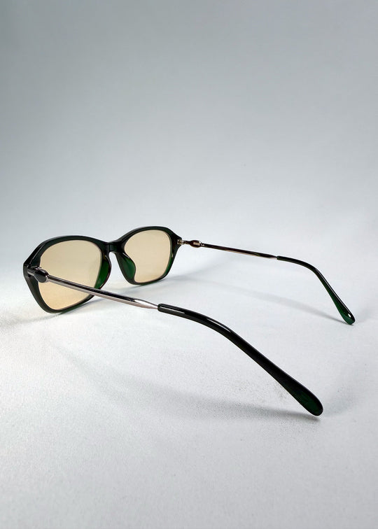 Side-temple view of Ravynor Softint sunglasses in Jade Shadow showing stainless-steel temples and deep green frame curvature. 