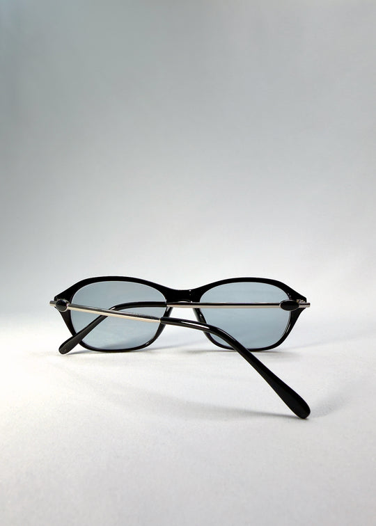 Back-angle view of Ravynor Softint sunglasses in Noir Alloy showing glossy black acetate frame and silver alloy temples.