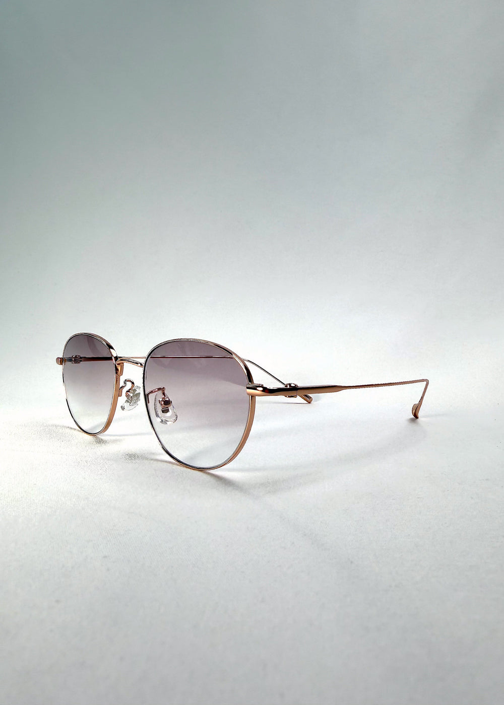 Side-temple view of Solen Softint sunglasses in Dawnveil, showing the ultra-slim titanium temples and adjustable nose pads.