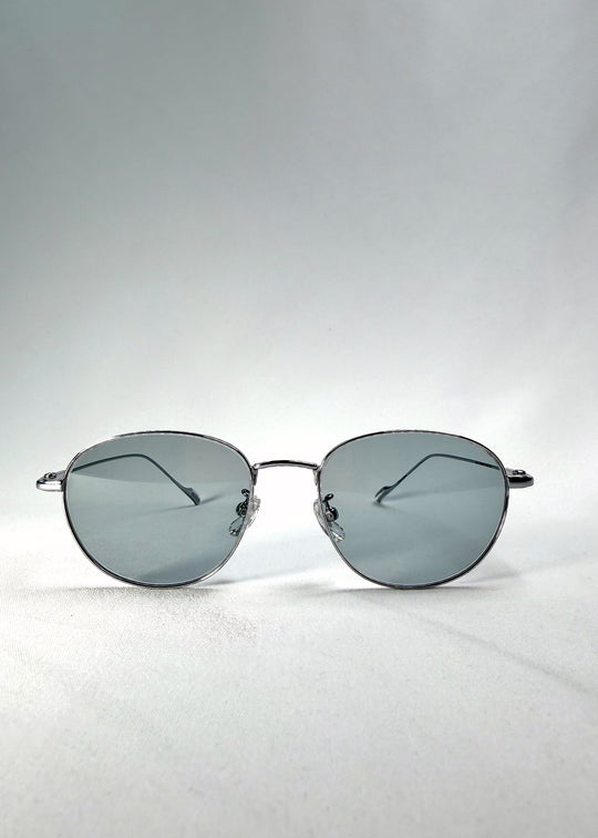 Front-angle view of Solen Softint sunglasses in Moonveil, showing the silver stainless-steel frame and pale blue-grey lenses. 