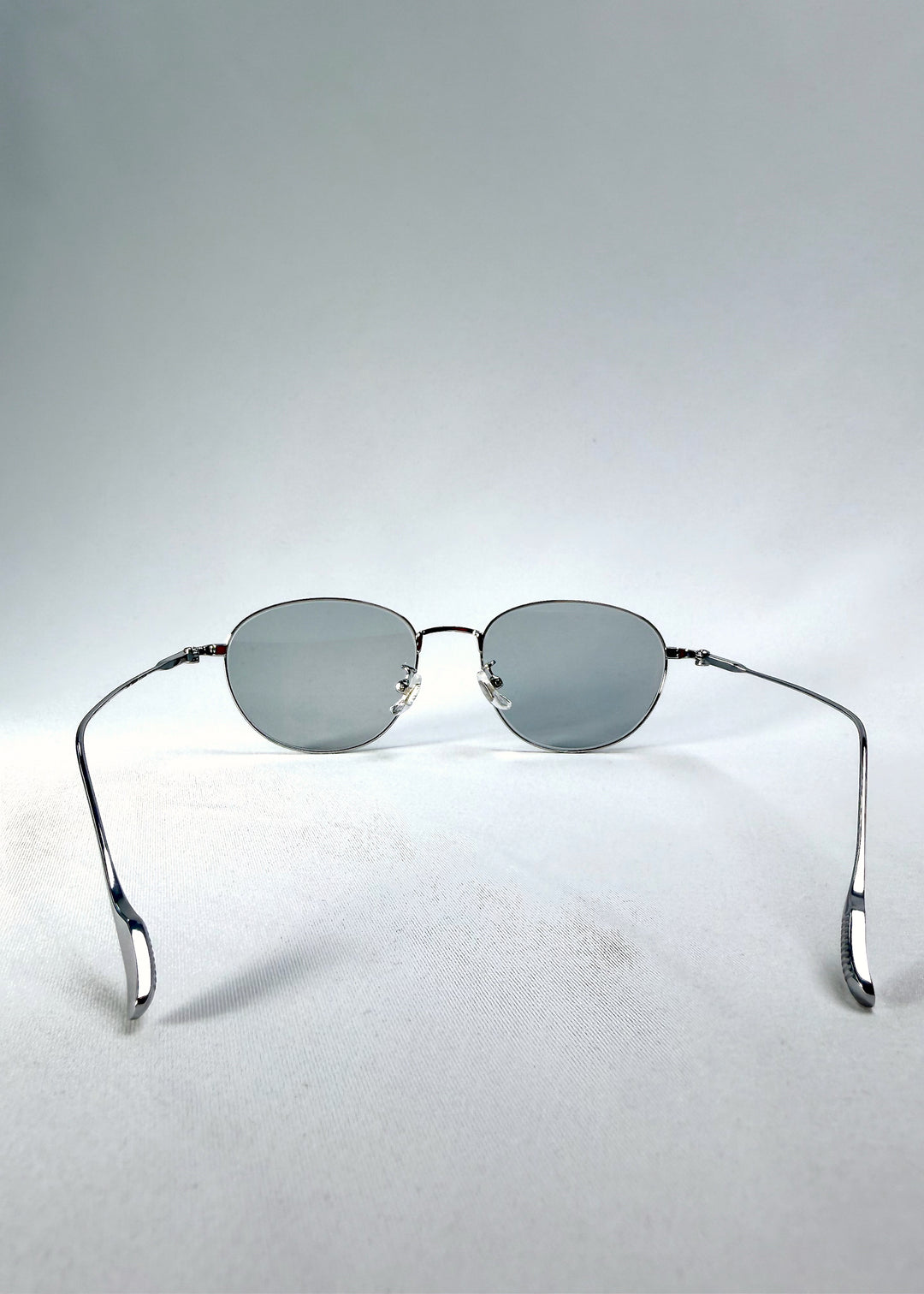 Front view of Solen Softint sunglasses in Moonveil showing silver frame and pale blue-grey lenses.