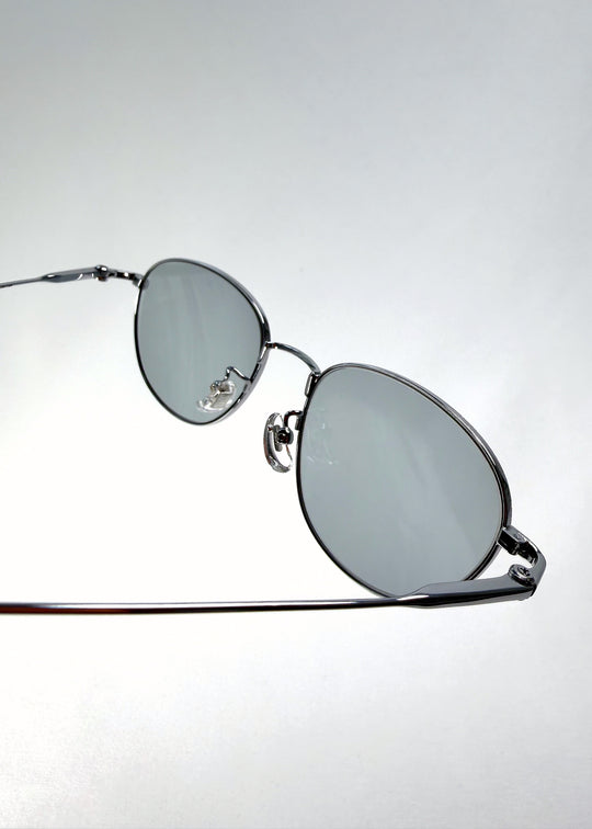 Close-up of Solen Softint sunglasses in Moonveil showing metal hinge and Softint lens detail.