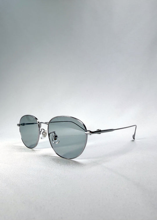 Side-temple view of Solen Softint sunglasses in Moonveil, showing the ultra-slim titanium temples and adjustable nose pads. 