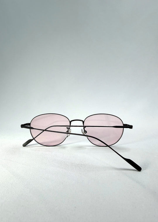 Folded-front view of Solen Softint sunglasses in Nightveil highlighting slender metal frame and soft pink tint.