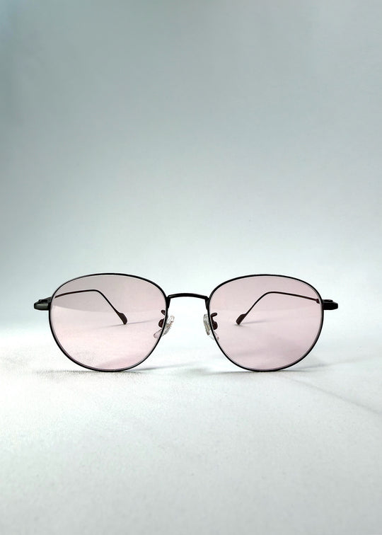 Front view of Solen Softint sunglasses in Nightveil showing matte black frame and pale rose lenses.