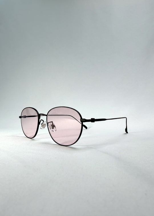 Left three-quarter front view of Solen Softint sunglasses in Nightveil, highlighting the rounded silhouette and pale rose lenses. 