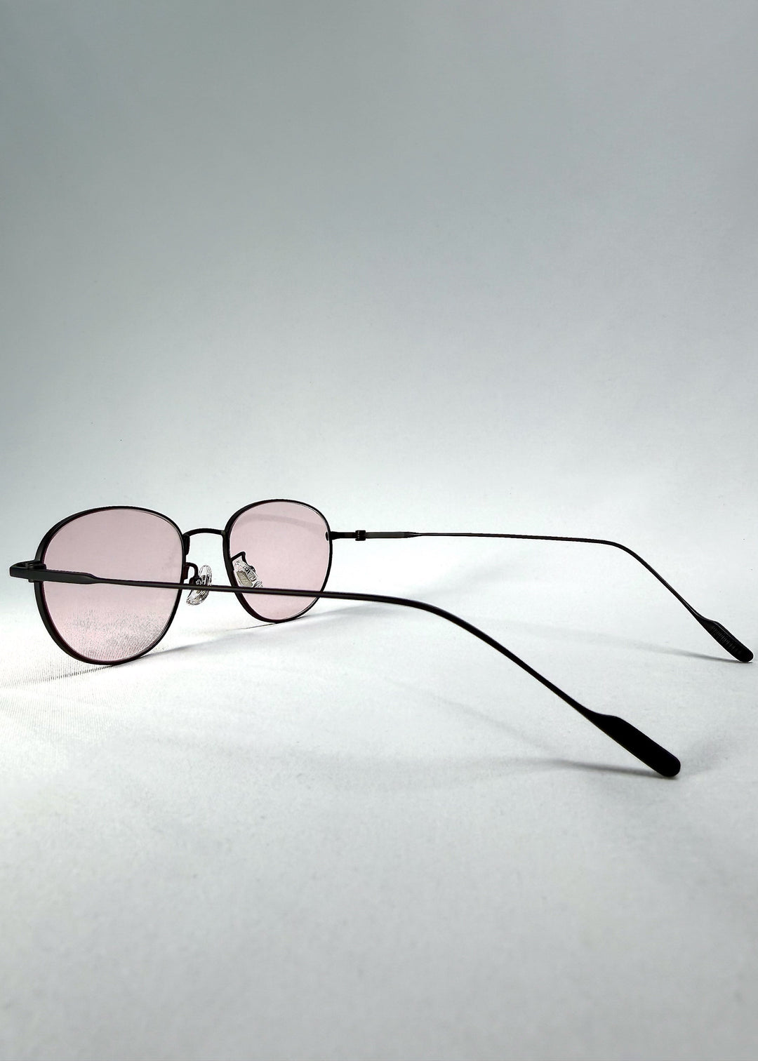 Side-temple view of Solen Softint sunglasses in Nightveil, showing the ultra-slim titanium temples and adjustable nose pads. 