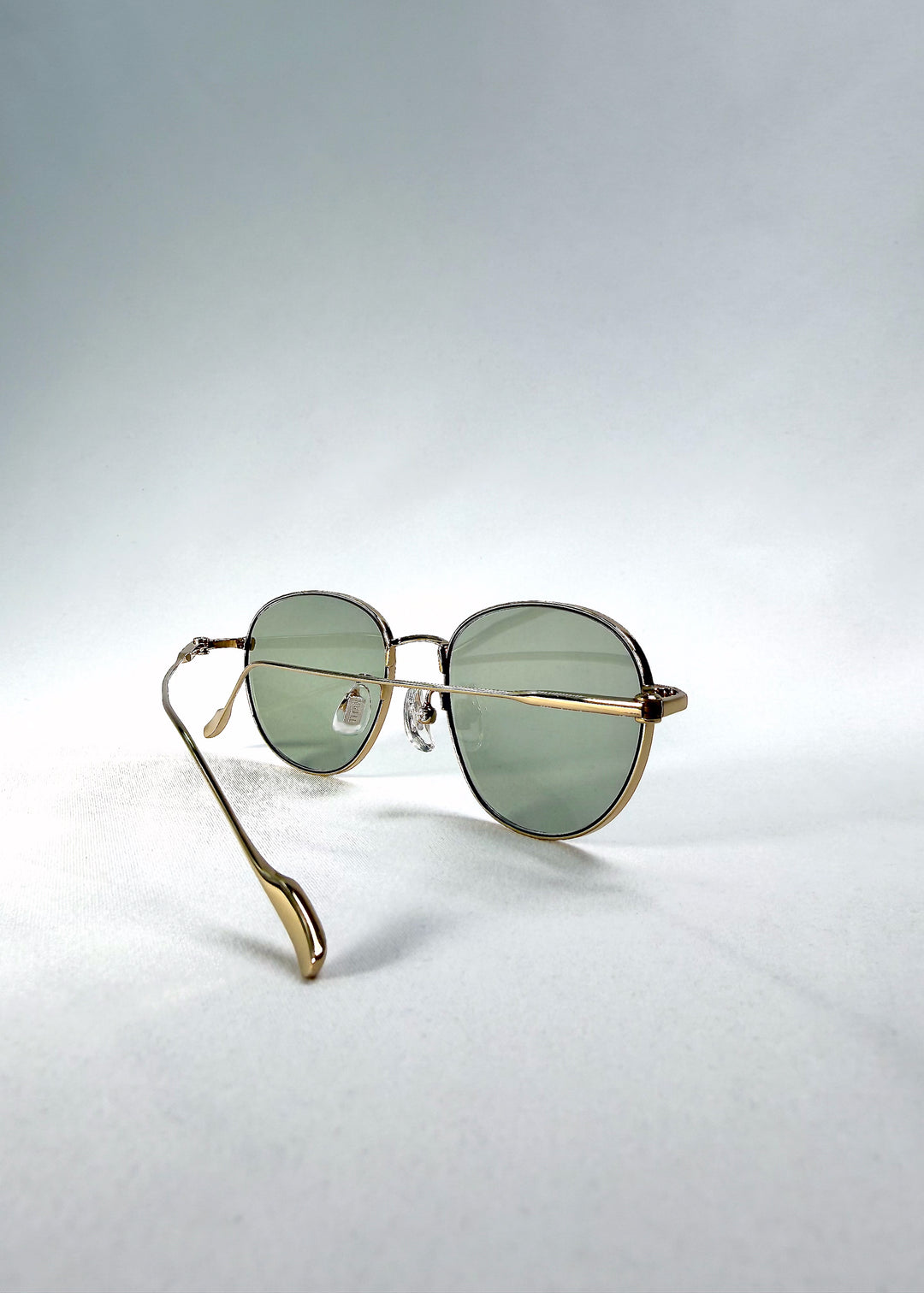 Folded-angle view of Solen Softint sunglasses in Sunveil displaying elegant metal construction.