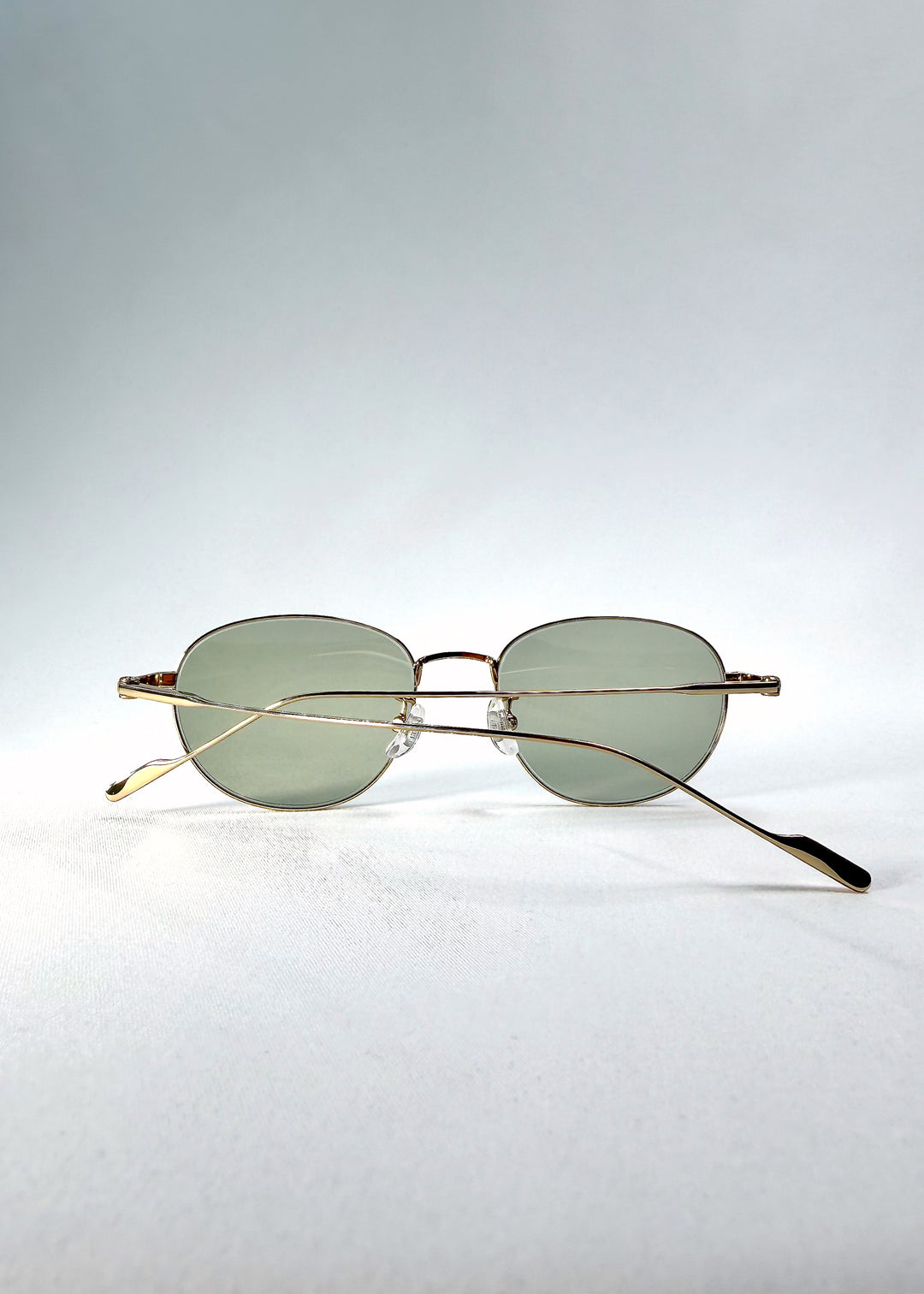 Folded-angle view of Solen Softint sunglasses in Sunveil displaying elegant metal construction.