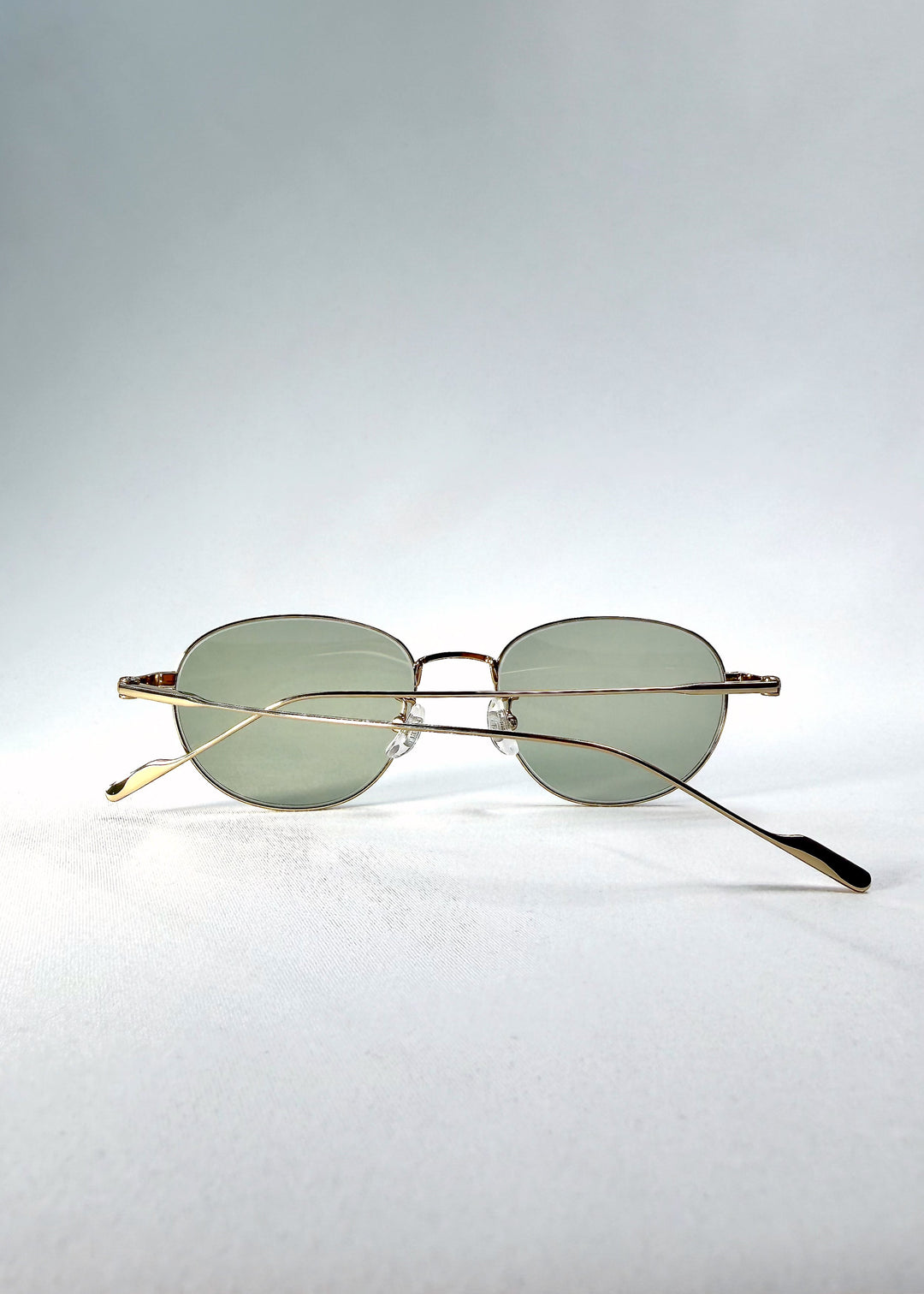 Inside view of Solen Softint sunglasses in Sunveil, showing the crossed titanium temples and adjustable nose pads. 