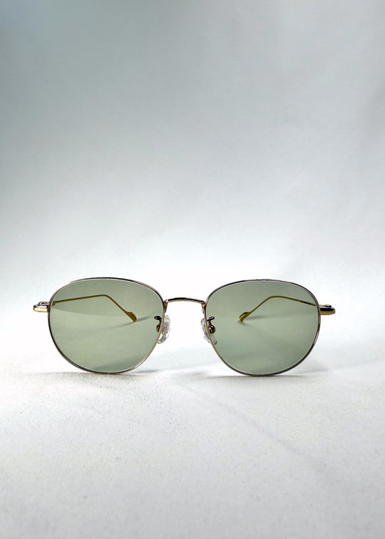 Front view of Solen Softint sunglasses in Sunveil, showing the gold stainless-steel frame and pale green lenses. 