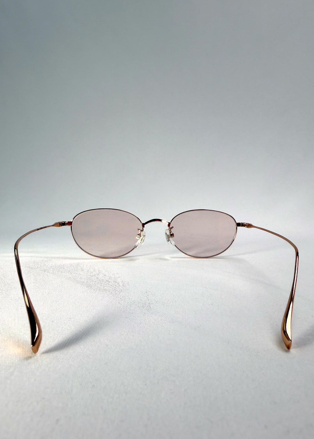Back view of Vanta Arc Softint sunglasses in Champagne Gold showing the lightweight titanium temples and curved arms. 