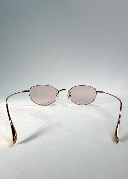 Back view of Vanta Arc Softint sunglasses in Champagne Gold showing the lightweight titanium temples and curved arms. 