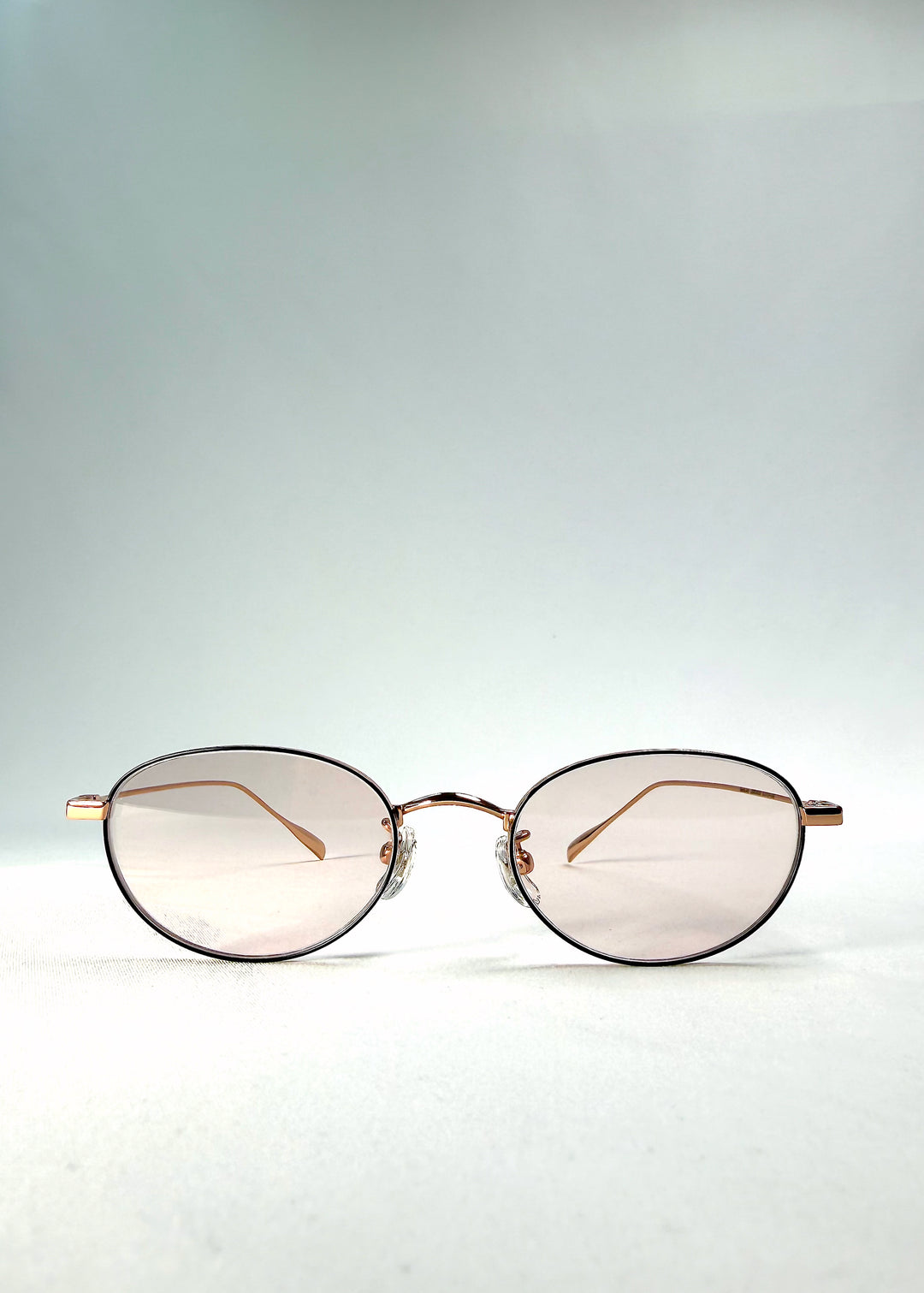 Front view of Vanta Arc Softint sunglasses in Duskgold showing gold frame and rose-beige lenses with UV400 protection.