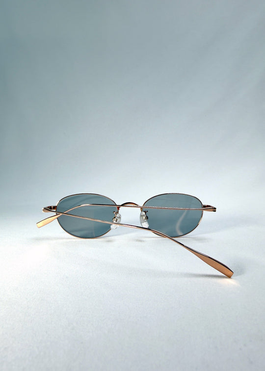 Folded front view of Vanta Arc Softint sunglasses in Sage Rose showing the rose-gold frame and smoke-green lenses. 