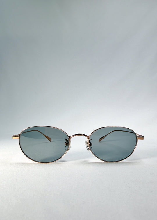 Front view of Vanta Arc Softint sunglasses in Sage Rose showing the rose-gold oval frame and smoke-green lenses. 
