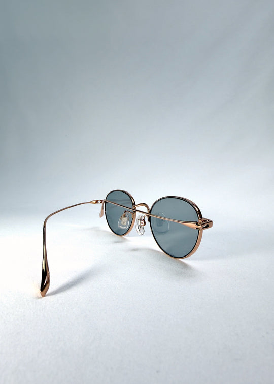 Left front-angle view of Vanta Arc Softint sunglasses in Sage Rose showing the slim frame and smoke-green lens tone. 
