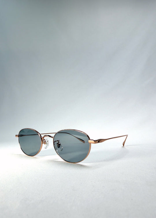 Right front-angle view of Vanta Arc Softint sunglasses in Sage Rose showing the slim rose-gold frame and smoke-green lenses. 