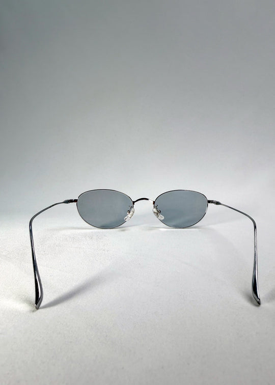 Back view of Vanta Arc Softint sunglasses in Glacial Silver showing the titanium temples and clean oval lines. 