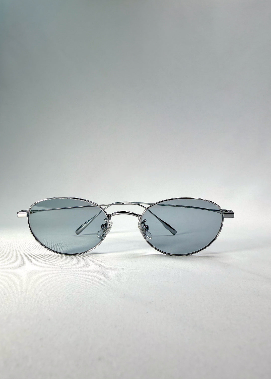 Folded front view of Vanta Arc Softint sunglasses in Silver Vein showing brushed-silver frame and cool lens tone.