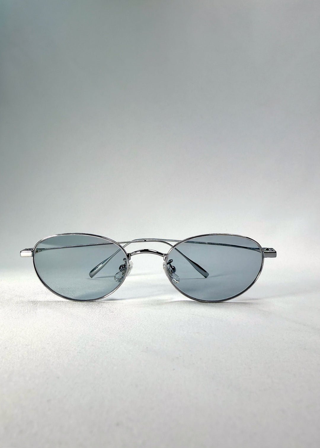 Folded front view of Vanta Arc Softint sunglasses in Glacial Silver showing the brushed-silver frame and cool lens tone. 