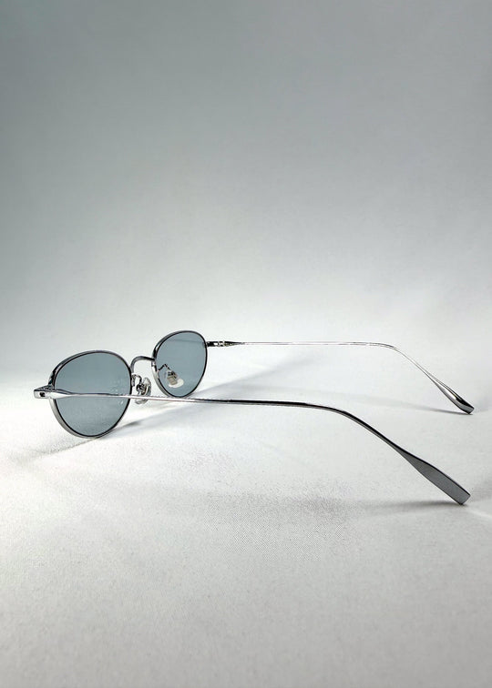 Side-temple view of Vanta Arc Softint sunglasses in Glacial Silver showing the slim silver titanium arms. 