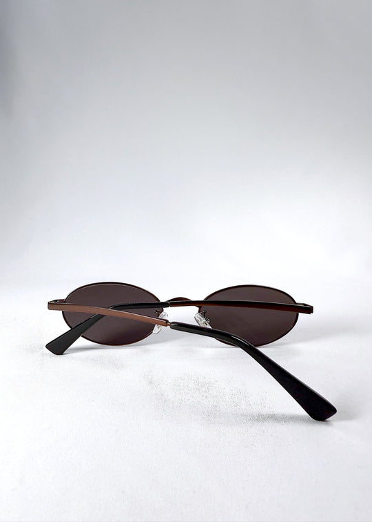 Back view of Solstice – Espresso Bronze sunglasses in folded position, highlighting the curved temples and dark acetate tips. 