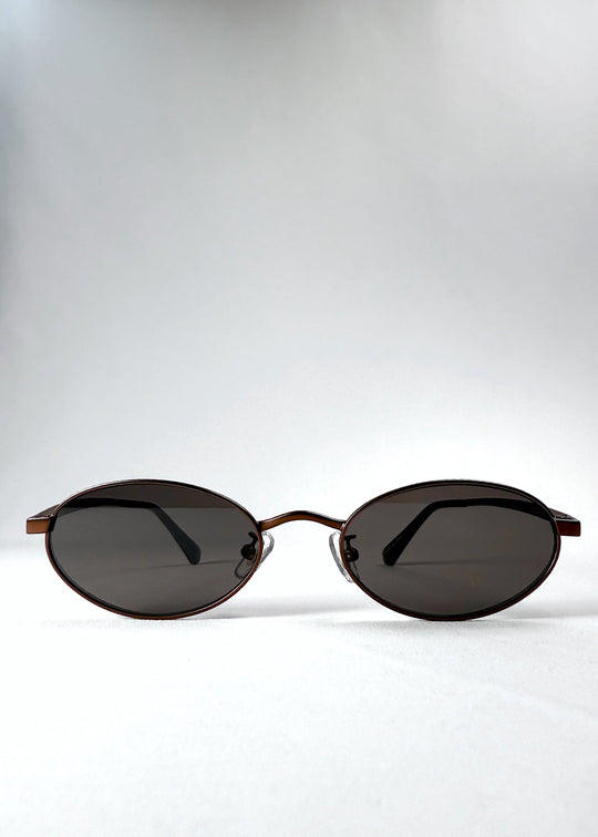 Front view of Solstice – Espresso Bronze sunglasses showing the espresso-toned oval frame and smoky brown lenses. 