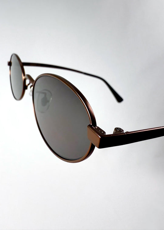Close-up of the hinge and temple connection on Solstice sunglasses in Espresso Bronze. 