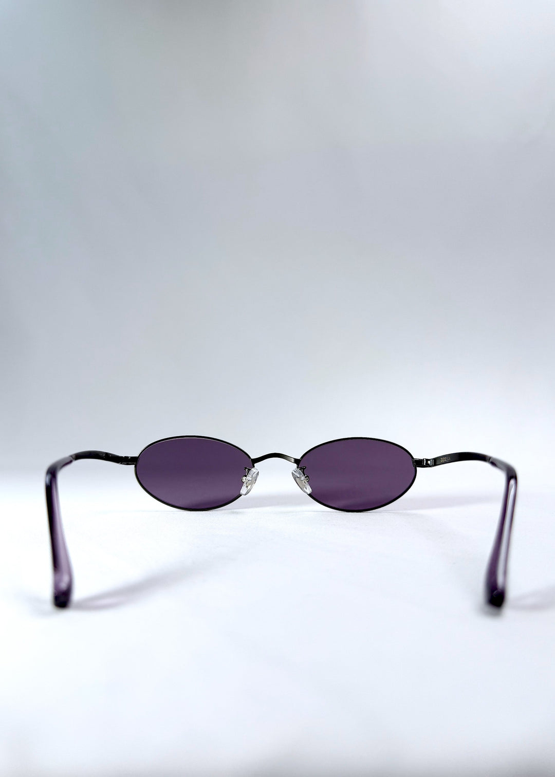 Back view of Solstice – Gunmetal Frost sunglasses showing nose pads and open temple arms. 