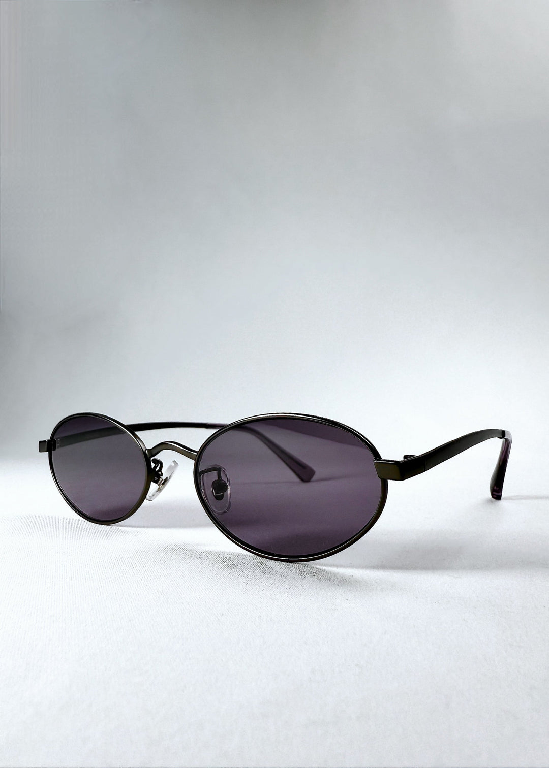 Angled front view of Solstice – Gunmetal Frost showing lens curvature and frame contour. 